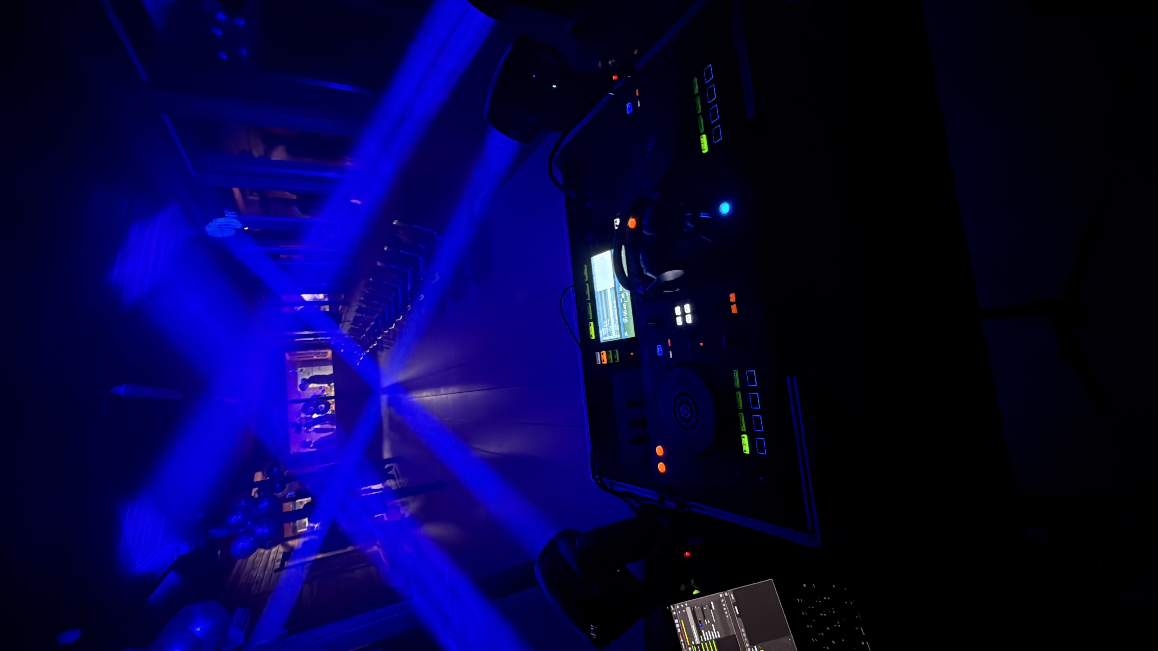Establishing Footage with Professional DJ Equipment on a Club Stage. Mixing Decks, Controllers and Other Gear Standing on a Table, Ready to Be Used by a Popular Music Artist in Front of Audience
